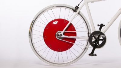 A bicycle with a red disc attached, transformed into an electric hybrid.