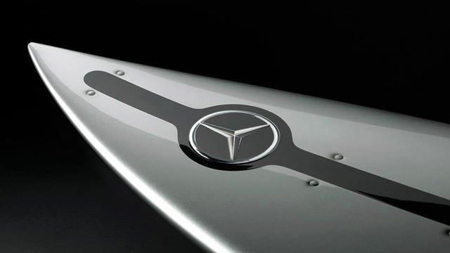 A sleek silver finish complete with Mercedes logo and rivet artwork make this board look more like a part of a car than a surfboard.