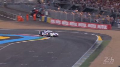 A Le Mans race car speeds down the track, thrilling the crowd.