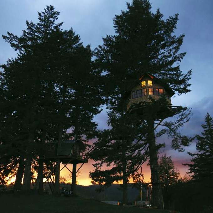 Treehouse lit up at sunset