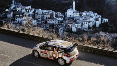 A WRC rally car racing down a mountain road.