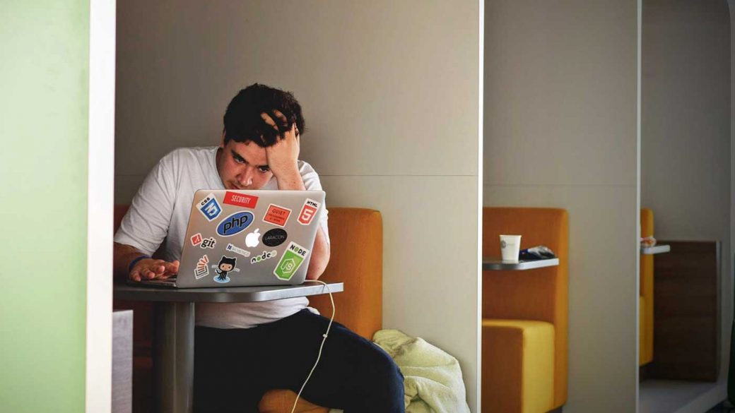 Man trying to concentrate in front of a laptop