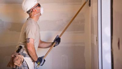 Man sanding plasterboard