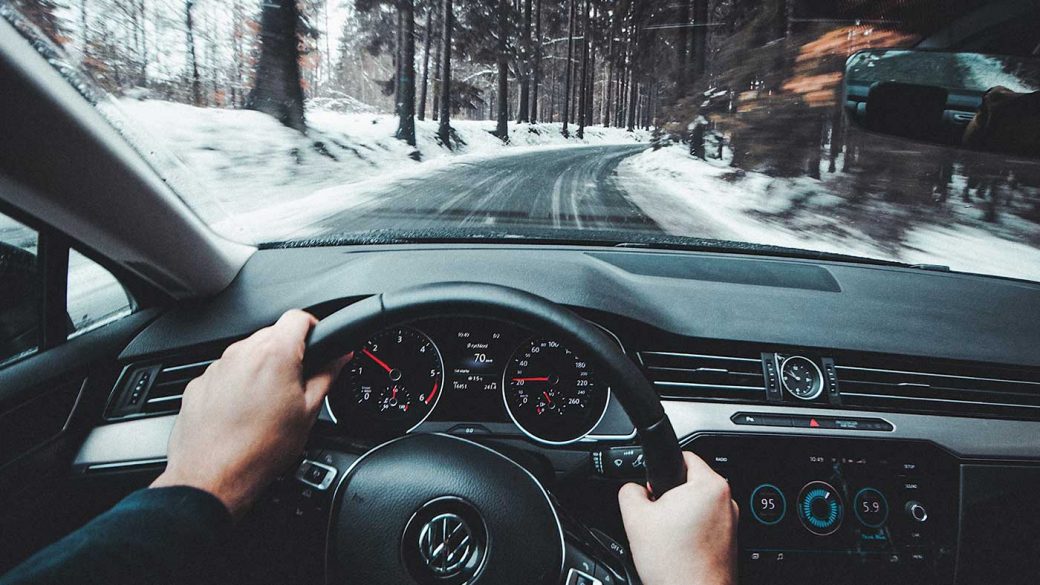 Person driving car in winter conditions