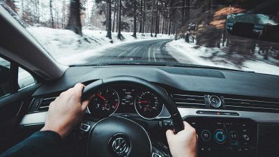 Person driving car in winter conditions