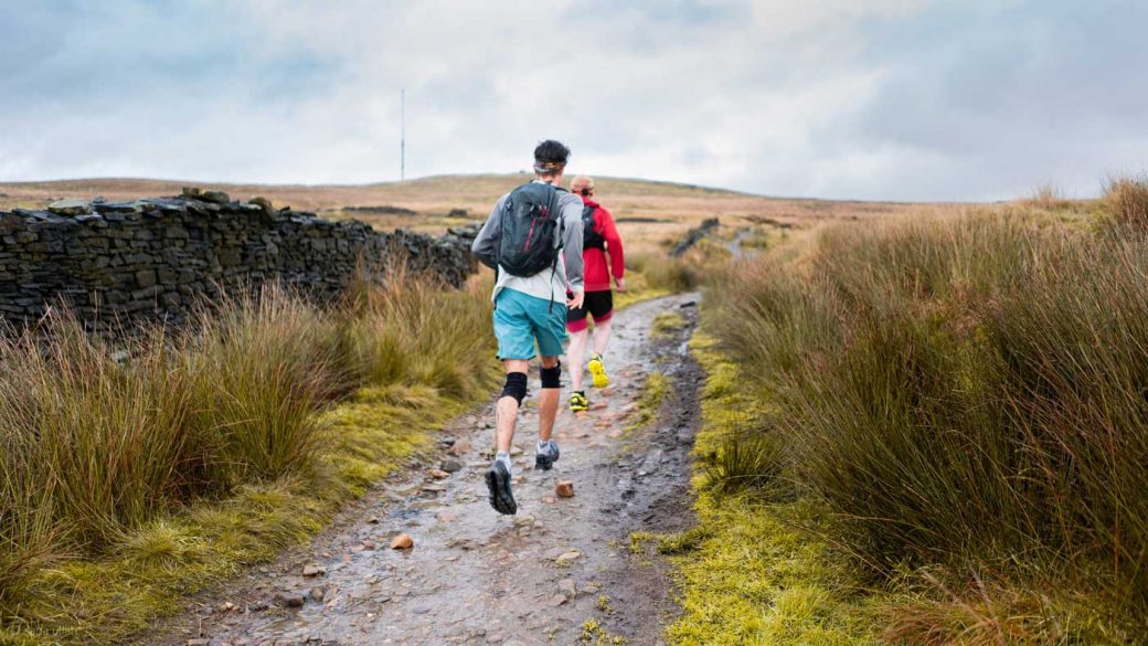 Man running with knee supports