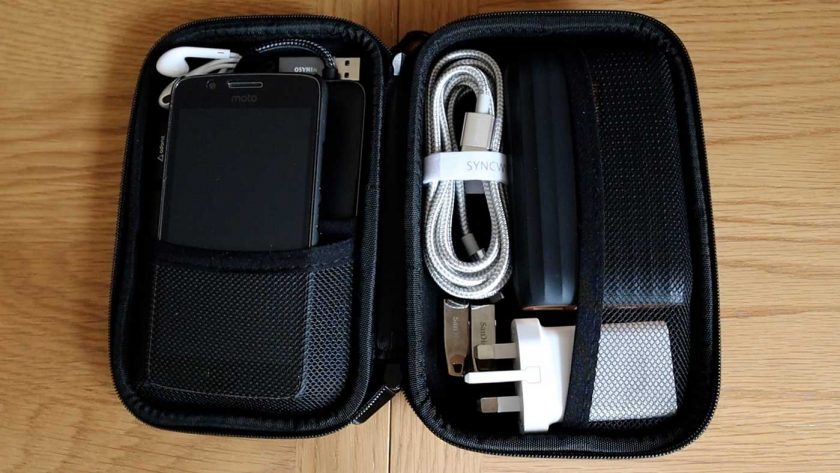 A selection of small electronics, cables and tech accessories organised in the Syncwire travel case