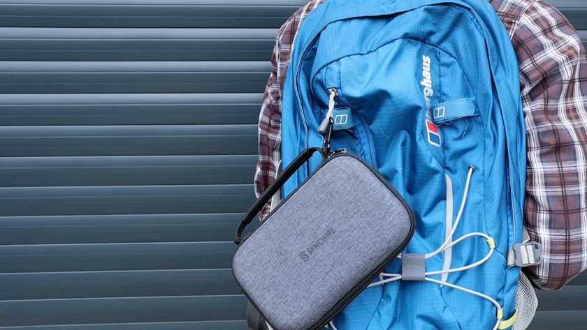 The Syncwire travel case attached to the outside of a backpack