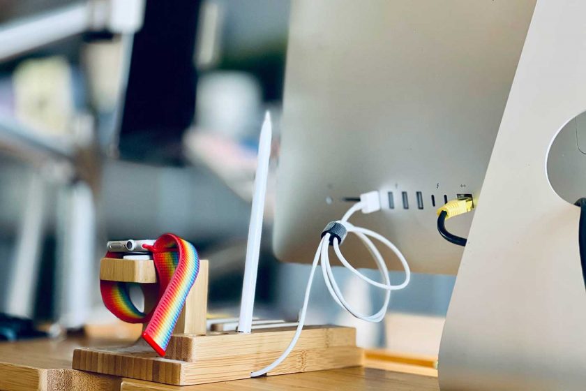 USB cable plugged into the back of a desktop PC and organised with a cable tie