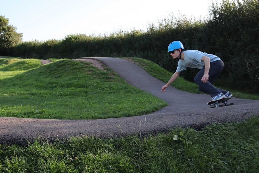 Skateboarding on a pump track while wearing the Vallon Howlin’ sunglasses
