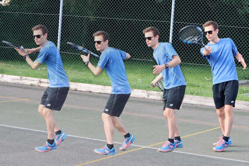 Playing a forehand tennis shot on an outdoor tennis court while wearing the Vallon Howlin’ sunglasses
