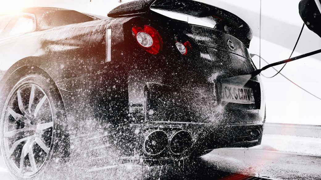 Car being washed using a pressure washer