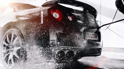 Car being washed using a pressure washer