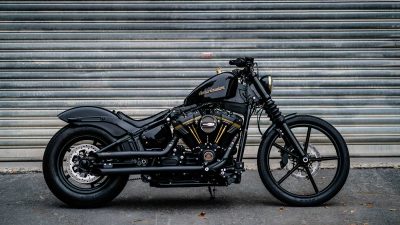 Black Harley-Davidson motorcycle parked against a grey wall