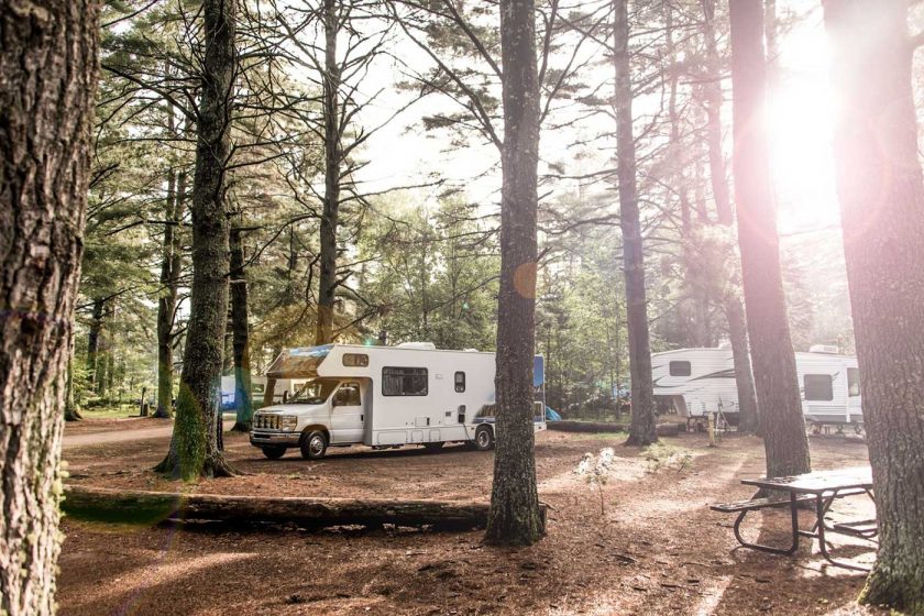 Motorhome parked in a woodland campground