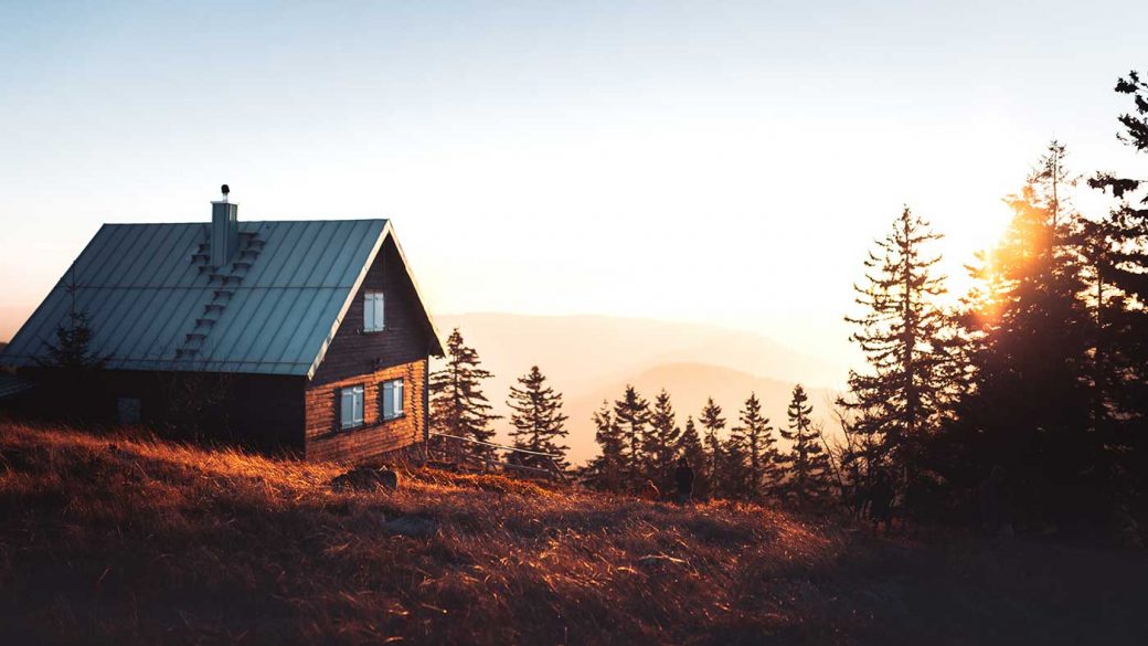 Off-grid mountain cabin at sunset