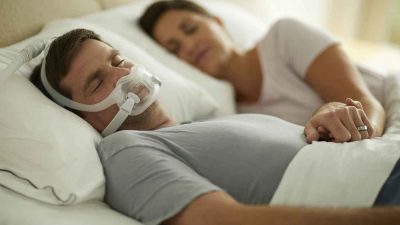 Man using a CPAP machine while sleeping