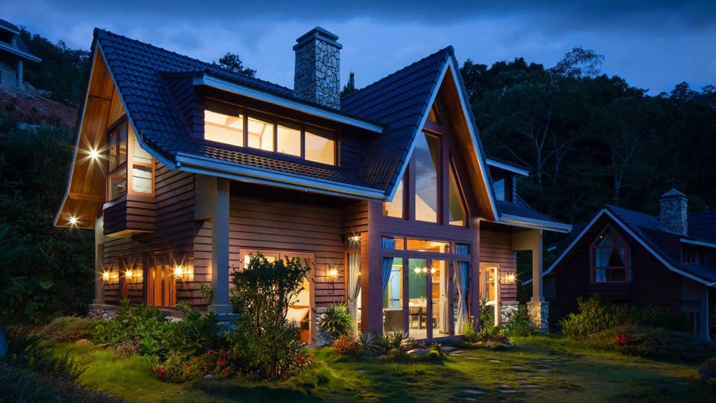 Modern wooden house lit at night