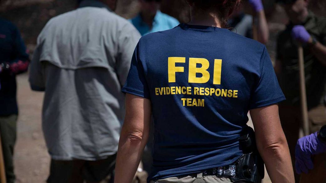 An FBI special agent collecting evidence at a crime scene