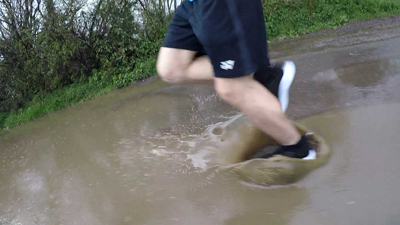 Running through a deep puddle with the Loom footwear waterproof sneakers