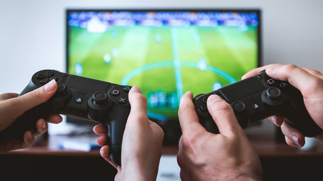 Two people playing Fifa 22 on Playstation