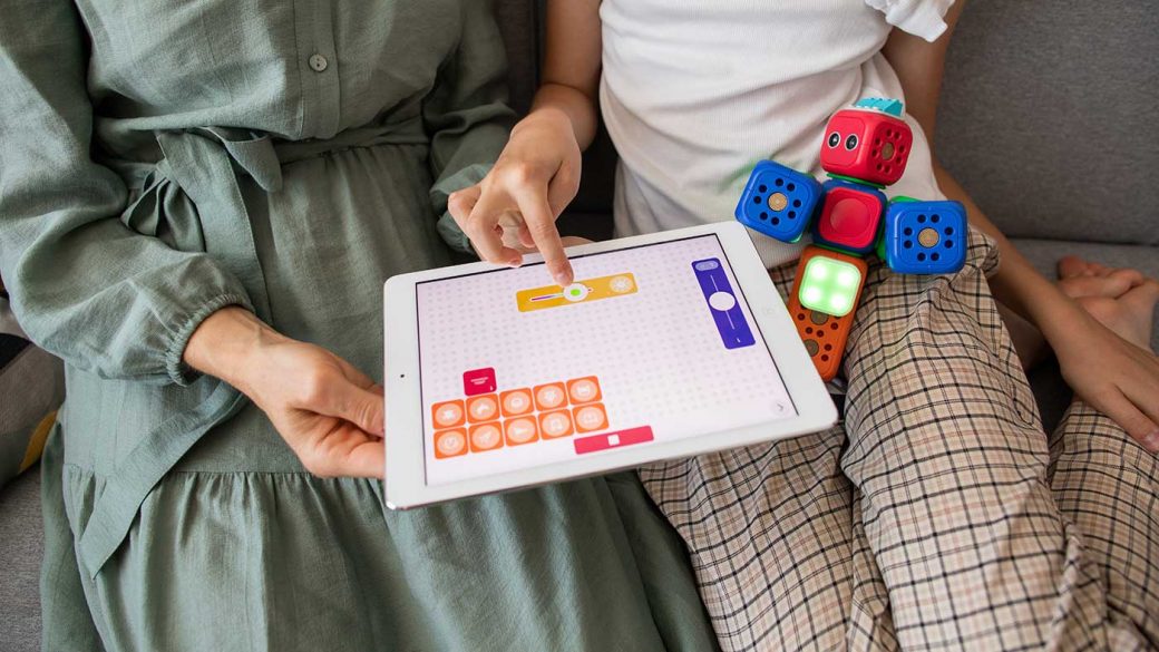 Mother playing an educational child-friendly app with her daughter