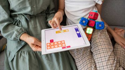 Mother playing an educational child-friendly app with her daughter