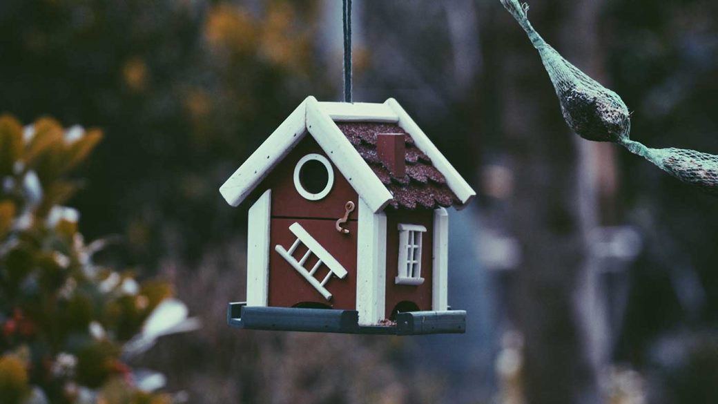 A bird feeder shaped like a house