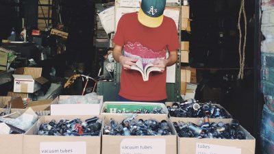 Man browsing through boxes of car parts