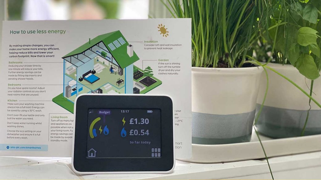 A smart energy meter next to a leaflet explaining the mistakes that increase energy bills