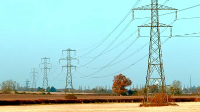 Electricity pylons running across UK countryside