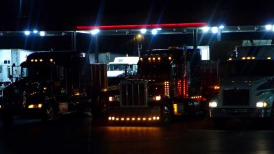 Truck drivers parked in a Florida truck stop having completed their allotted hours of service