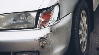 Dent in the front bumper of a silver car