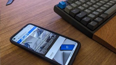Smartphone on desk with web browser open viewing adaptnetwork.com