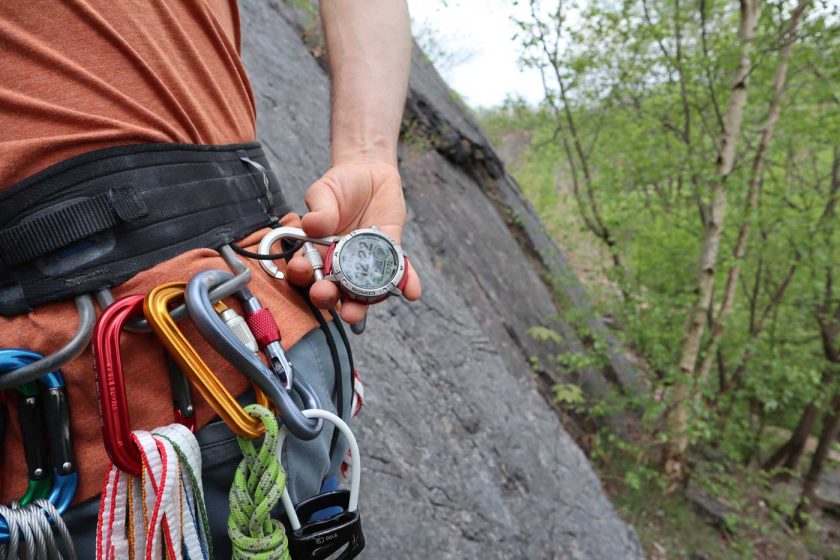 Clipping the Coros Vertix 2 carabiner to the haul loop of my harness when trad climbing