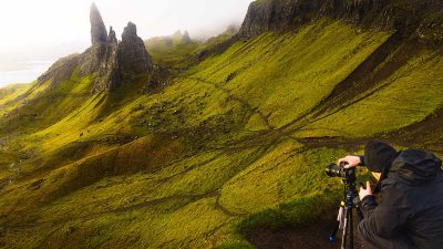 An outdoor photographer photographing the Old Man of Stor on The Isle of Skye in Scotland