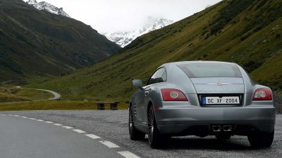 Silver chrysler on a mountain road